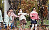 Children from the Buk District local government office workplace daycare center in Gwangju enjoy the colorful late autumn foliage on Thursday at a park commemorating the May 18 Gwangju Democratization Movement at the main gate of Chonnam National University. [NEWS1]