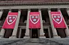 Harvard University’s motto, “veritas,” is displayed on banners in front of the Harry Elkins Widener Memorial Library at Harvard University in Cambridge, Mass., Sept. 6, 2024. Instead of speaking out on the hot-button debates of the day, more schools are making it a policy to stay silent as political pressure mounts against higher education. (Sophie Park/The New York Times)