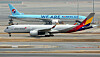 An Asiana Airlines aircraft taxis past a Korean Air plane on the runway at Incheon International Airport on Tuesday. [NEWS1]