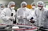 President Moon Jae-in, center, talks with SK Group Chairman Chey Tae-won, far right, Wednesday while touring a SK Bioscience factory in Andong, North Gyeongsang. [YONHAP]