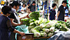 Consumers shop for napa cabbages at a traditional market in Seoul on Sunday amid soaring grocery prices. [NEWS1]
