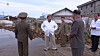 North Korean leader Kim Jong-un, center, inspects an area damaged by Typhoon Maysak in the country's eastern South Hamkyong Province, in a photo published by the Rodong Sinmun, the official newspaper of the ruling party, earlier this month. [YONHAP]