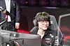 T1 mid laner Lee ″Faker″ Sang-hyeok smiles while setting up on stage. [RIOT GAMES]