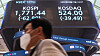 A person walks past a screen with the Kospi close at the Korea Exchange building in Yeouido, western Seoul. [YONHAP]