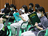 Highschool seniors read workbooks while waiting to receive Covid-19 vaccine shots at a vaccination center in Daejeon on Monday, 101 days before the country's College Scholastic Ability Test (CSAT) in November. [NEWS1]