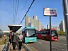 People stand at a bus stop near Geolpo Bukbyeon Station in Gimpo to get on a bus on Monday morning. [JANG SEO-YUN]