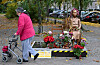 A pedestrian passes a statue representing victims of Japanese wartime sexual slavery that is decorated with flowers in Berlin’s Mitte district on Oct. 27. Civic activists fought to retain the 'comfort women' statue after the Japanese government requested its removal to German officials. [AFP/YONHAP]