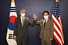 South Korea's top nuclear envoy, Noh Kyu-duk, right, and his U.S. counterpart, Sung Kim, bump their fists ahead of a meeting at The Plaza Hotel in central Seoul Monday morning to discuss efforts to get North Korea to return to the dialogue table, including humanitarian cooperation. [JOINT PRESS CORPS]