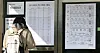A student taking this year's College Scholastic Ability Test checks her designated test venue at Ewha Girls' High School in Jung District, central Seoul, on Wednesday. [YONHAP]
