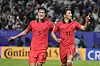 Hwang Hee-chan, right, celebrates after scoring [AP/YONHAP]