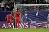 Korea's Hwang Hee-chan, left, scores the equalizer against Australian goalkeeper Mathew Ryan late in stoppage time at Al Janoub Stadium in Al Wakrah, Qatar on Friday [AP/YONHAP]