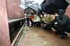President Yoon Suk-yeol and Seoul Mayor Oh Se-hoon, second and third from left, inspect flood damage in Sillim-dong, Gwanak District, southern Seoul on Tuesday. [JOINT PRESS CORPS]