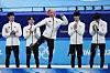 Kwak Yoon-gy, center, celebrates during the victory ceremony after Korea's second place finish in the men's 5,000-meter relay final at Capital Indoor Stadium at the 2022 Winter Olympics on Feb. 16. [AP/YONHAP]