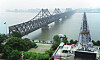 The Friendship Bridge in Dandong, right, connects rail lines between China and North Korea. The North recommenced overland rail operations in January this year, partially lifting a self-imposed blockade on border trade that has lasted almost 2 years. [AP]