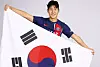 Lee Kang-in poses with the Korean flag while wearing a Paris Saint-Germain shirt in a photo released by the club on Saturday. [PARIS SAINT-GERMAIN]
