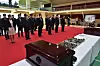 Military officials from South Korea and China pay their respects as the remains of 88 Chinese soldiers are placed in coffins in Incheon on Thursday. The Chinese soldiers were killed during the Korean War and their remains were recovered by a South Korean excavation unit. The coffins will be sent to China later. [DEFENSE MINISTRY]