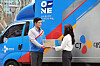 A customer receives a package from a CJ Logistics deliveryman. [CJ LOGISTICS]