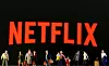 Small toy figures are seen in front of diplayed Netflix logo in this illustration taken March 19, 2020. [REUTERS/YONHAP]
