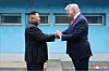 North Korean leader Kim Jong-un, left, and then-U.S. President Donald Trump shake hands across the Military Demarcation Line at Panmunjom on June 30, 2019, in this photo released by North's state media KCNA the following day. [YONHAP]