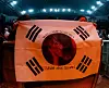 Fans hold up a Korean flag decorated with Sasha Alex Sloan's face during the singer's first concert in Korea held on Monday at the Yes24 Live Hall music venue in eastern Seoul as a part of her ″I Blame The World″ Asia tour. [LIVE NATION KOREA]