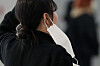 A passerby takes off her mask temporarily at the Incheon airport on Dec. 9. [NEWS1]