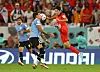 Korea's Lee Kang-in, right, in action with Uruguay's Jose Maria Gimenez during a Group H game at the 2022 Qatar World Cup at Education City Stadium in Qatar on Thursday. [REUTERS/YONHAP]
