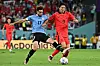 Cho Gue-sung, right, fights for the goal against Uruguay's defender Matias Vina during a 2022 Qatar World Cup Group H match between Uruguay and Korea at Education City Stadium in Al-Rayyan, west of Doha on Thursday. [AFP/YONHAP]