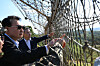 President Yoon Suk Yeol looks toward North Korea through a barbed-wire fence during a visit to the Army’s 25th Infantry Division in Yeoncheo County, Gyeonggi, on Sunday to mark the 75th Armed Forces Day during the Chuseok holiday. [PRESIDENTIAL OFFICE]