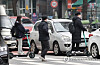 People ride electric scooters across a street near Hoegi Station in eastern Seoul on Thursday. A revised law that enables people to ride electric scooters in bike lanes went into effect that day. Under the revised law, people aged 13 or older can ride on scooters without a driver’s license; however, from April next year, all electric scooters will require a motorcycle license and only those aged 16 or older will be eligible to obtain one. [YONHAP]