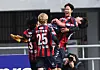 Lee Seung-woo of Suwon FC, center, celebrates with his teammates after scoring against Daegu FC at Suwon Stadium in Suwon, Gyeonggi on Sunday. [YONHAP]