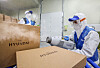 Workers from Hyundai Department Store disinfect packages as part of preventive measures against Covid-19. [HYUNDAI DEPARTMENT STORE]
