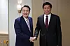 Korean President Yoon Suk-yeol, left, shakes hands with Li Zhanshu, chairman of China’s Standing Committee of the National People's Congress, in a meeting at the presidential office in Yongsan District, central Seoul, Friday. [PRESIDENTIAL OFFICE]