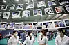 Health workers look at photos hung inside the vaccination center in Gwangju on Monday, after the district office installed a photo exhibition to thank the medical staff for their hard work during the Covid-19 pandemic. [NEWS1]