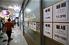 A woman passes by a real estate agency near Gangdong Lotte Castle First apartment complex in Gangdong District, eastern Seoul. No jeonse offers are posted. [JANG JIN-YOUNG]