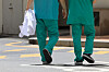 Two medical professionals walk in a general hospital's compound on Thursday in Seoul. [YONHAP]