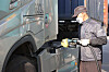 A gas station employee in Euiwang, Gyeonggi, on Wednesday fills up DEF on a cargo truck. [YONHAP]