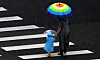 A child and an adult hold umbrellas while crossing a road in Wanju County, North Jeolla, as rain falls on Sunday. [NEWS1]