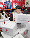 Employees of the Korean Red Cross sort boxes of disaster relief supplies at the charity organization's Suwon branch on Wednesday. Around 600 residents in Gangneung, Gangwon, had to evacuate due to a huge wildfire that broke out Tuesday. [YONHAP]