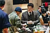 North Korean defector chef Kim Won-jun, left, prepares a dish as Paik Jong-won, a judge on Netflix’s 'Culinary Class Wars' (2024), looks on. [KIM WON-JUN]