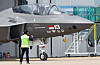 A prototype of the KF-21 fighter jet under development bearing the flags of Korea and Indonesia moves out of a hangar at the headquarters of Korea Aerospace Industries in Sacheon, South Gyeongsang, on Tuesday. [YONHAP]