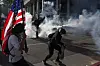 Demonstrators protest amid tear gas during a ″No Kings Day″ protest against President Donald Trump's policies, in Los Angeles, California, on June 14. [REUTERS/YONHAP]