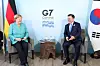 Korean President Moon Jae-in, right, discusses vaccine cooperation with German Chancellor Angela Merkel during a bilateral meeting on the sidelines of the G7 summit in Cornwall, England, on June 12. Moon also held a series of bilateral meetings with the leaders of Britain, Australia, France and the European Union. [YONHAP]