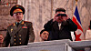 In this photo released by the North's state-controlled Korean Central Television, regime leader Kim Jong-un, right, peers through binoculars at a military parade that took place in Pyongyang on Thursday to celebrate the 70th anniversary of the signing of the armistice that ended the 1950-53 Korean War. Russian Defense Minister Sergei Shoigu stands on the left. [YONHAP]
