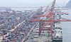 Cranes load containers for export on outbound ships at a port in Busan on June 12. [YONHAP]