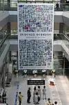 The banner exhibiting the portraits of 388 Korean War veterans is placed at the Nam District Office in Busan on Thursday to commemorate the 71st anniversary of the outbreak of the Korean War and the 70th anniversary of the foundation of the UN Memorial Cemetery in Korea in Busan. [SONG BONG-GEUN]