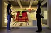 Visitors look at wedding gowns worn by women of the Joseon Dynasty at the National Palace Museum's ongoing exhibit, 'Blooming Hwarot: Bridal Robes of the Joseon Royal Court.' [YONHAP]