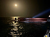 Coast Guard officials stand on the overturned keel of a capsized fishing vessel approximately 16.6 kilometers west of Daebichi-do, an island off the coast of Mokpo, South Jeolla, in the early hours of Sunday. [YONHAP]
