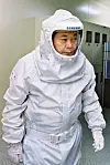 Samsung Group Chairman Lee Kun-hee dons a protective 'bunny suit' during a visit to a semiconductor facility in 2004. [SAMSUNG]