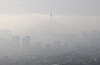 N Seoul Tower, a landmark Seoul building with a transmission antenna sitting atop Namsan, is seen above the city enveloped in a yellow haze as the fine dust concentration reached “bad” — the third highest level in a four-tier system — on March 13. The photo was taken from Mount Inwang in Jongno District, central Seoul.[YONHAP]