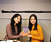 HA:TFELT, left, also known as Ye-eun, gifts her new book to Woo Hye-rim, right. Both were former members of Wonder Girls. [WOO HYE-RIM]